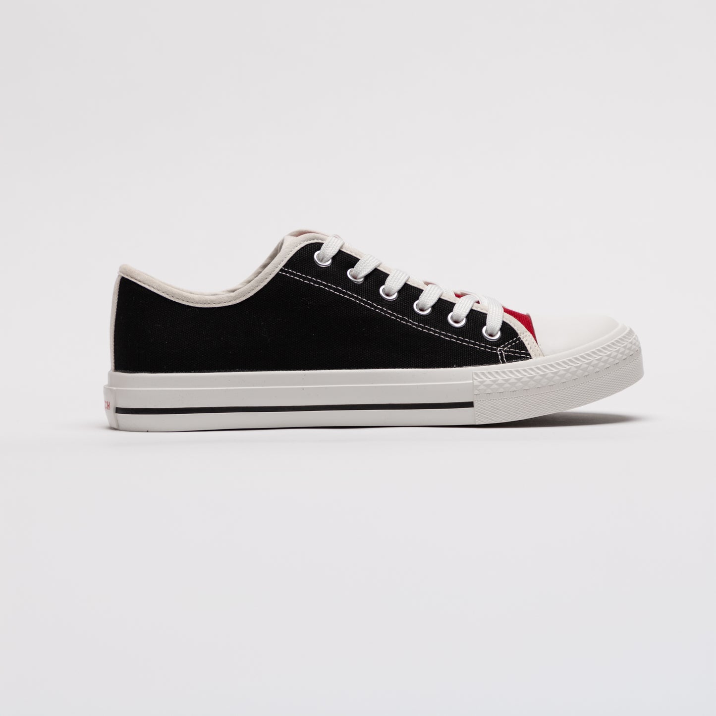 Right side profile of black mismatched sneaker from Mismatch Shop on white backdrop