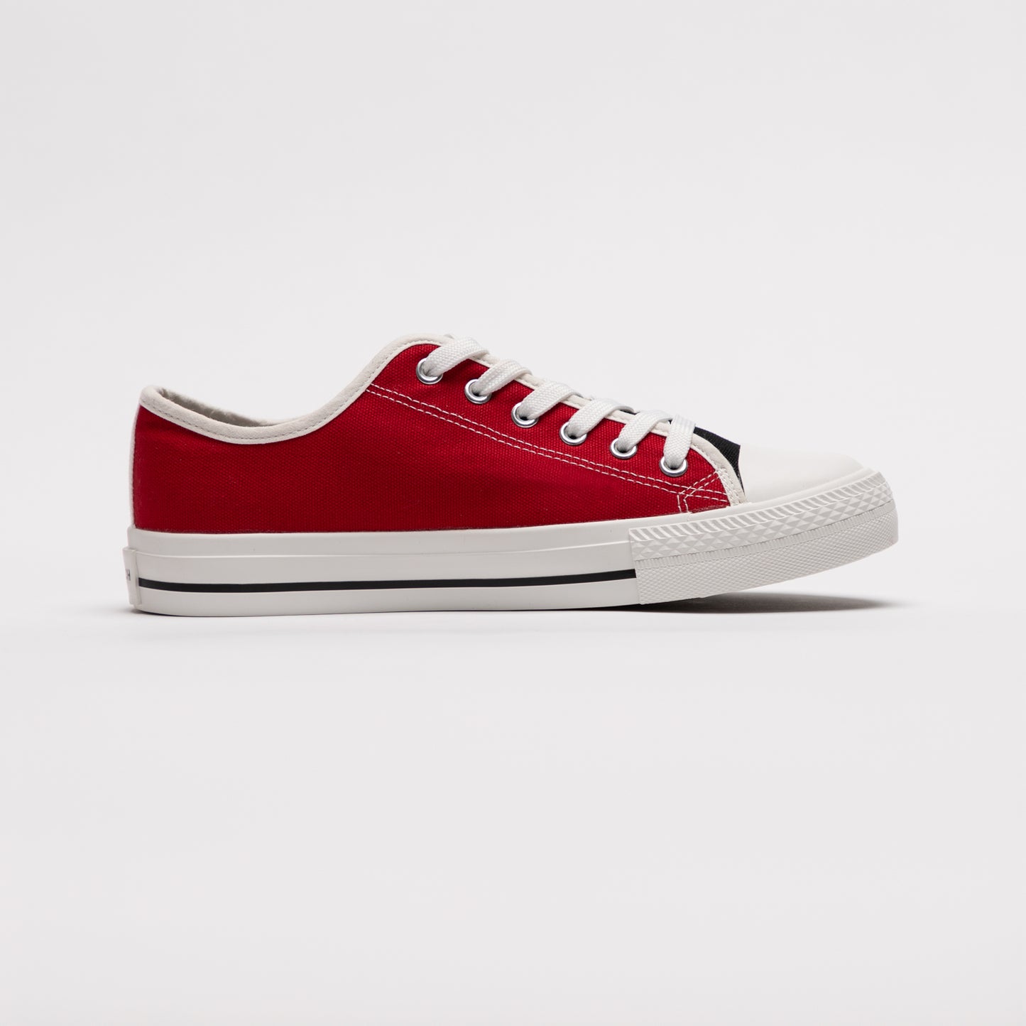 Right side profile of red mismatched sneaker from Mismatch Shop on white backdrop