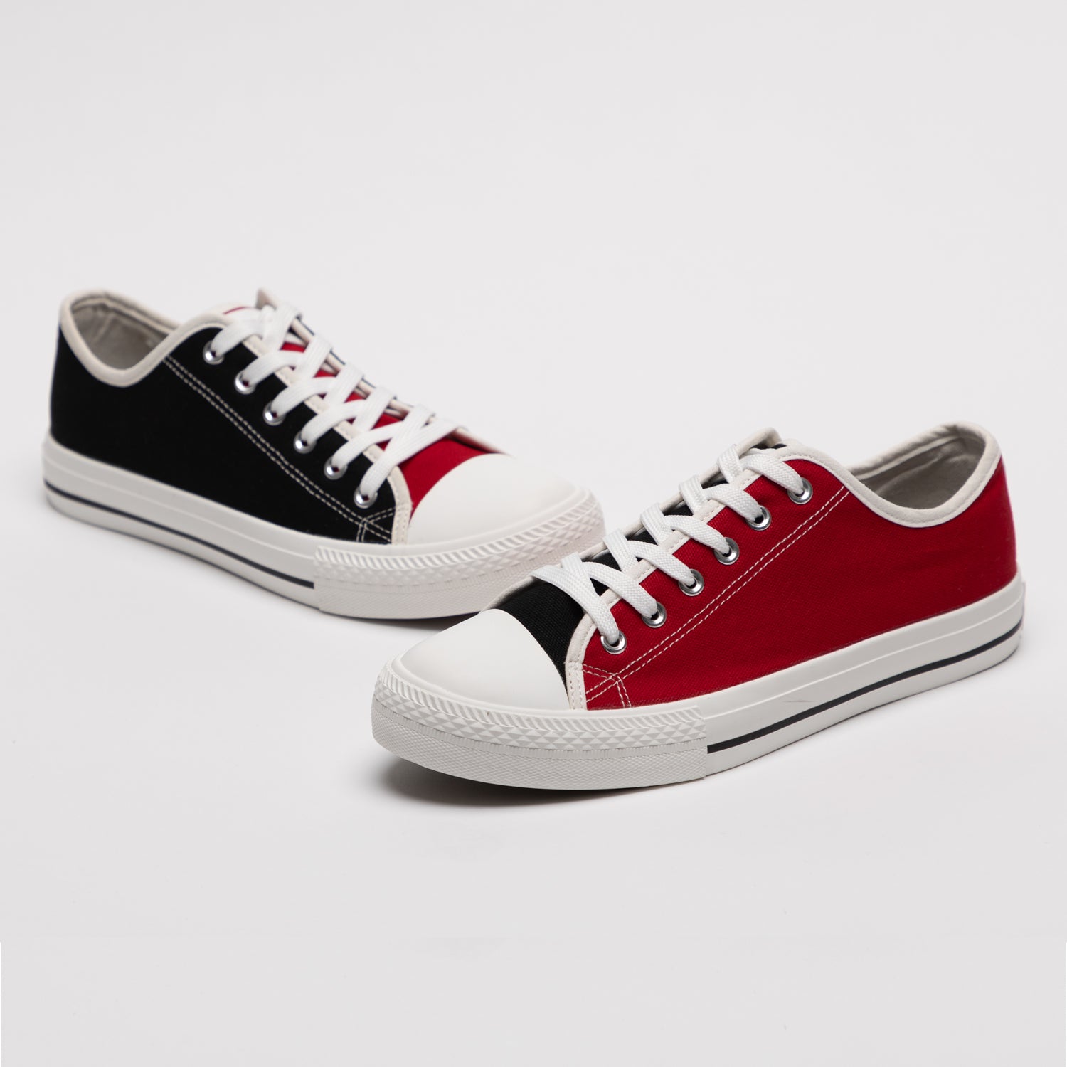 Red and black mismatched sneakers from Mismatch Shop, placed facing each other on a white background